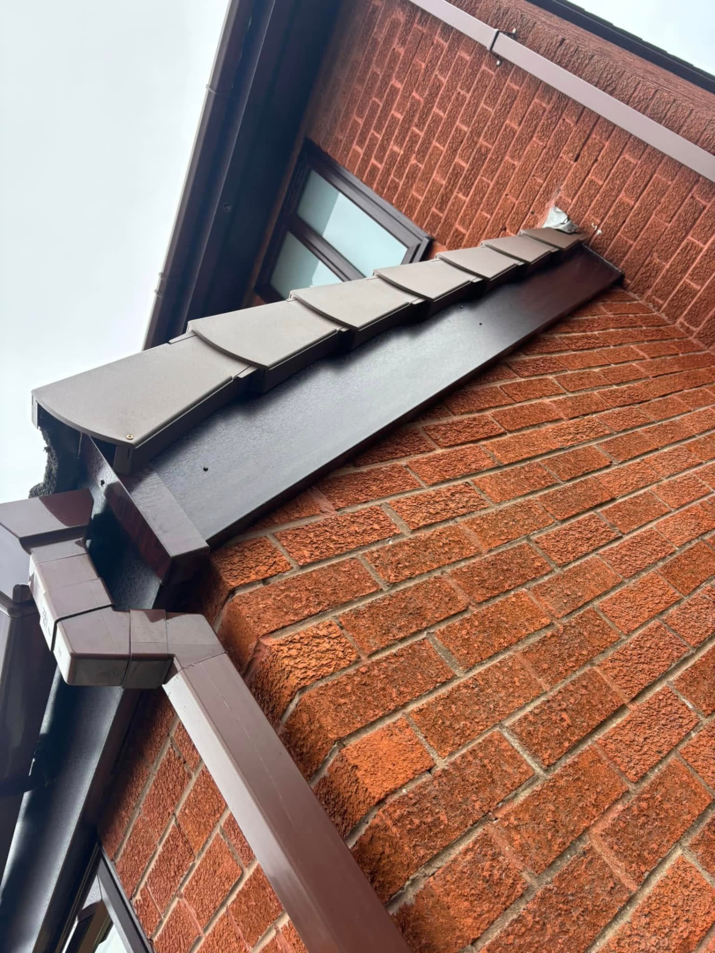 New brown bargeboard, fascia and gutter corner detail installed by MB Roofline & Joinery in the North West